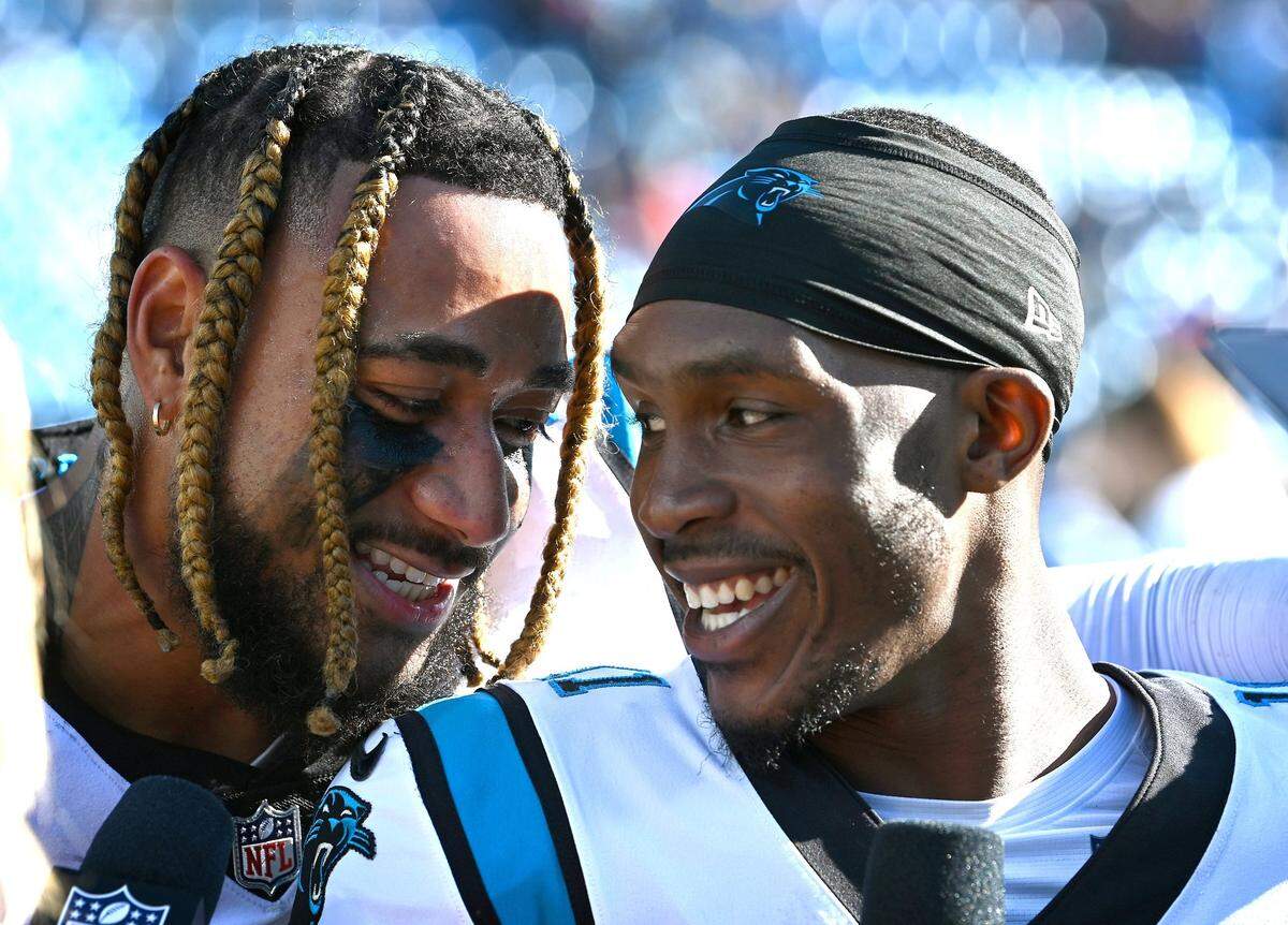 Carolina Panthers linebacker Frankie Luvu, left, celebrates the team’s 21-3 victory over the Tampa Bay Buccaneers with quarterback PJ Walker, right, at Bank of America Stadium in Charlotte, NC on Sunday, October 23, 2022.