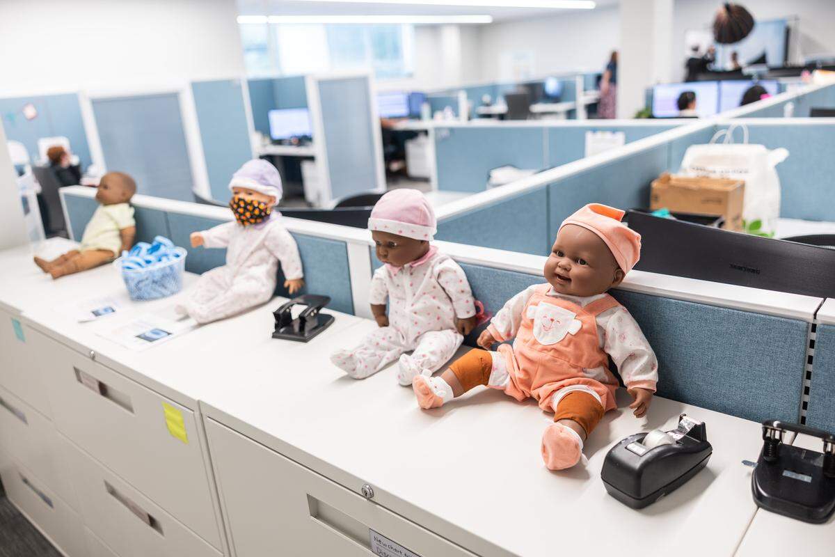 Baby dolls sit in the office area at Care Ring in Charlotte on Wednesday, August 13, 2025. Care Ring will enhance postnatal care by providing services for mothers and babies simultaneously.