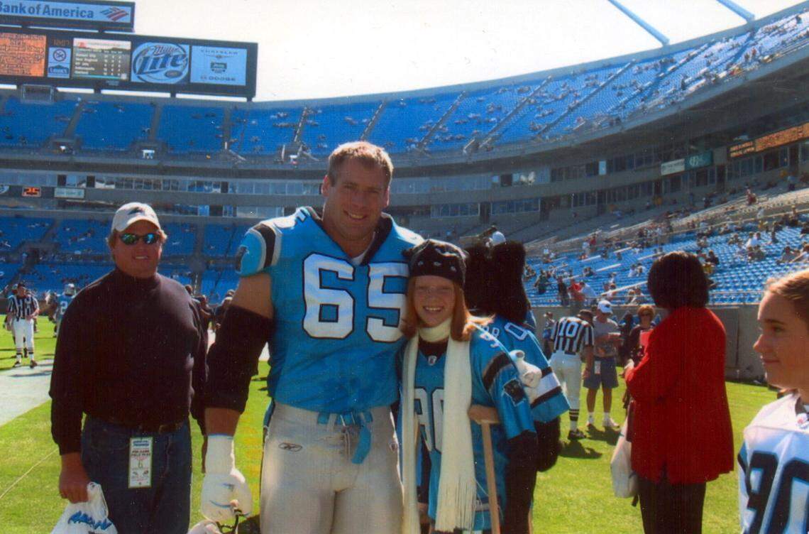 Carolina Panthers player Kevin Donnalley poses with Hope Stout at a Carolina Panthers game in October 2003.