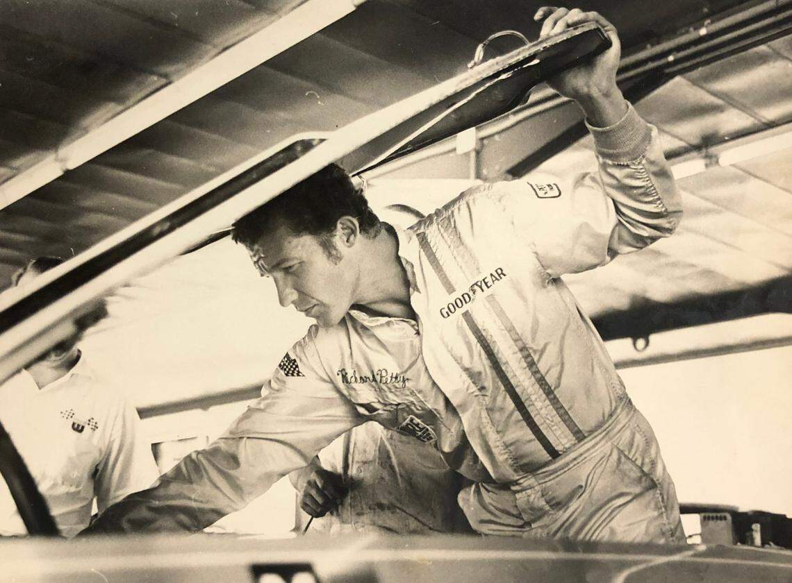 NASCAR driver Richard Petty looks over his engine in the garage on October 24, 1968.