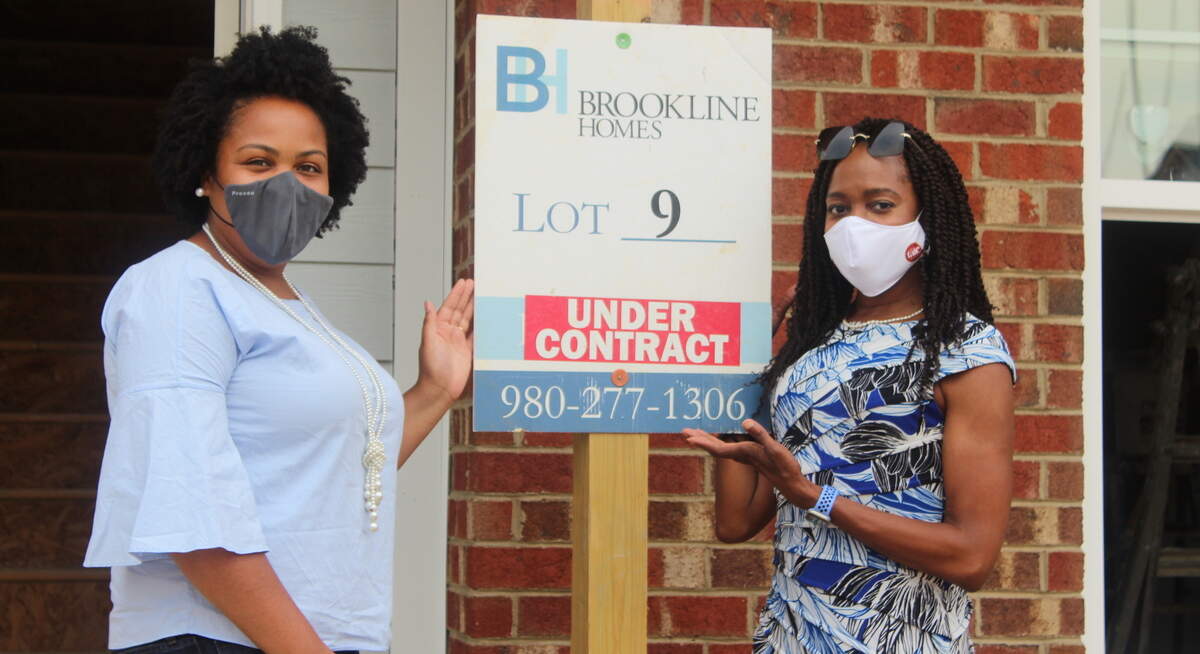 AllenTate realtor Mechelle Harris helps her client, Ashley Brown, safely close on a new construction property.