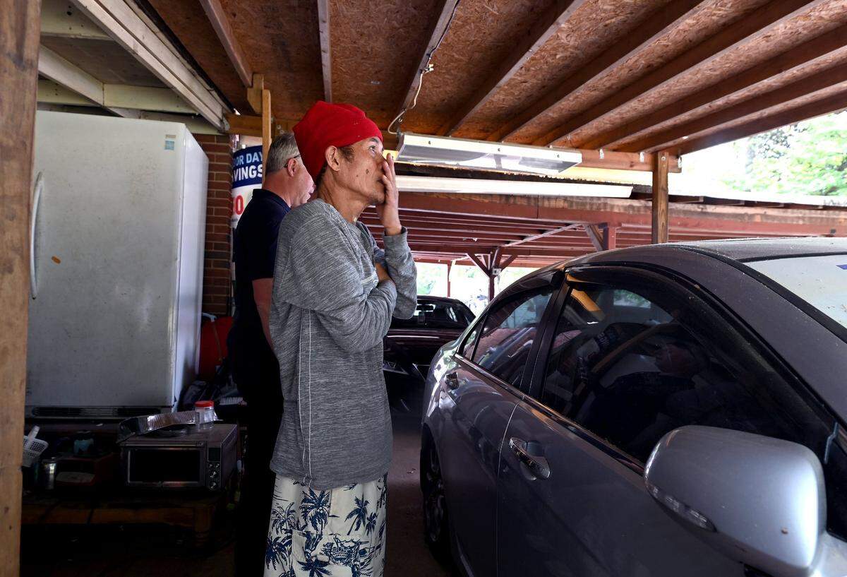 Saing Chhoeun looks at the home located at 5525 Galway Drive where three members of the U.S. Marshals task force and CMPD Officer Joshua Eyer were killed on Monday, April 29, 2024 when they were serving a warrant in east Charlotte. Four other officers were wounded during the shooting. Chhoeun stood behind the refrigerator/freezer at left as officers attempted to stop the shooter inside the home. Chhoeun was video taping the situation.