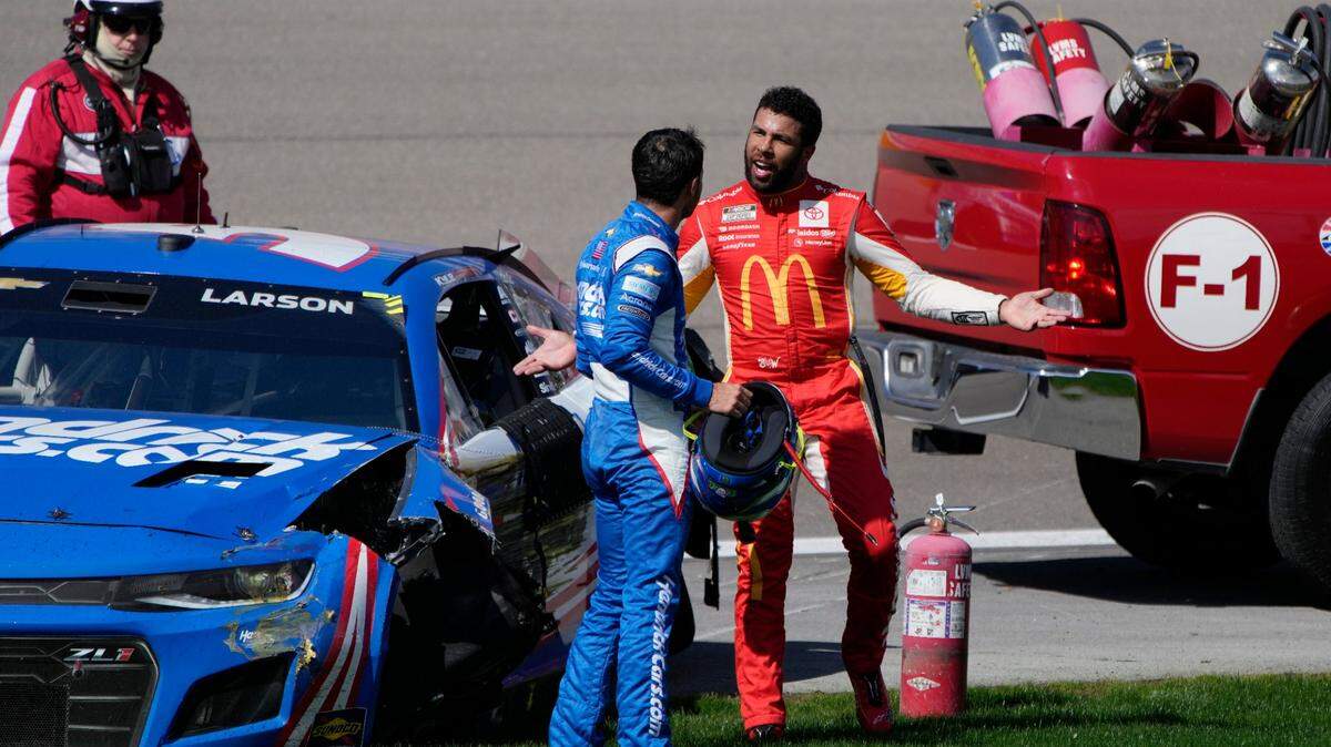 Kyle Larson, left, argues with Bubba Wallace after the two crashed during a NASCAR Cup Series auto race Sunday, Oct. 16, 2022, in Las Vegas. (AP Photo/John Locher)