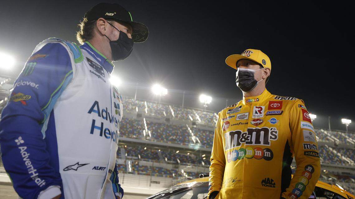 DAYTONA BEACH, FLORIDA - FEBRUARY 09: Kyle Busch, driver of the #18 M&M’s Toyota, and Kurt Busch, driver of the #1 AdventHealth Chevrolet, talk on the grid prior to the NASCAR Cup Series Busch Clash at Daytona at Daytona International Speedway on February 09, 2021 in Daytona Beach, Florida. (Photo by Jared C. Tilton/Getty Images)