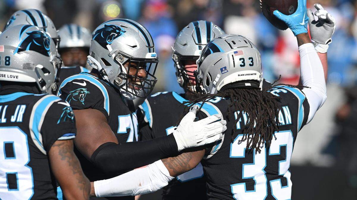 Carolina Panthers running back D’Onta Foreman, right, is congratulated by his teammates after rushing for a touchdown during second quarter action against the Detroit Lions at Bank of America Stadium on Saturday, December 24, 2022 in Charlotte, NC.