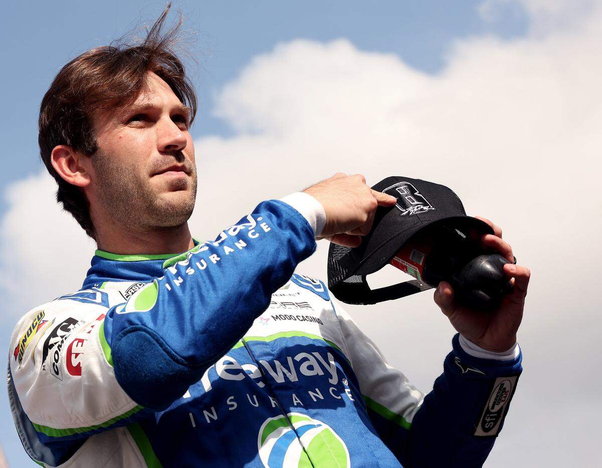NASCAR driver Daniel Suarez points to his hat in honor of driver Kyle Busch during driver introductions for the Coca-Cola 600 at Charlotte Motor Speedway in Concord, NC on Sunday, May 24, 2026. Busch passed away unexpectedly on Thursday, May 21, 2026.