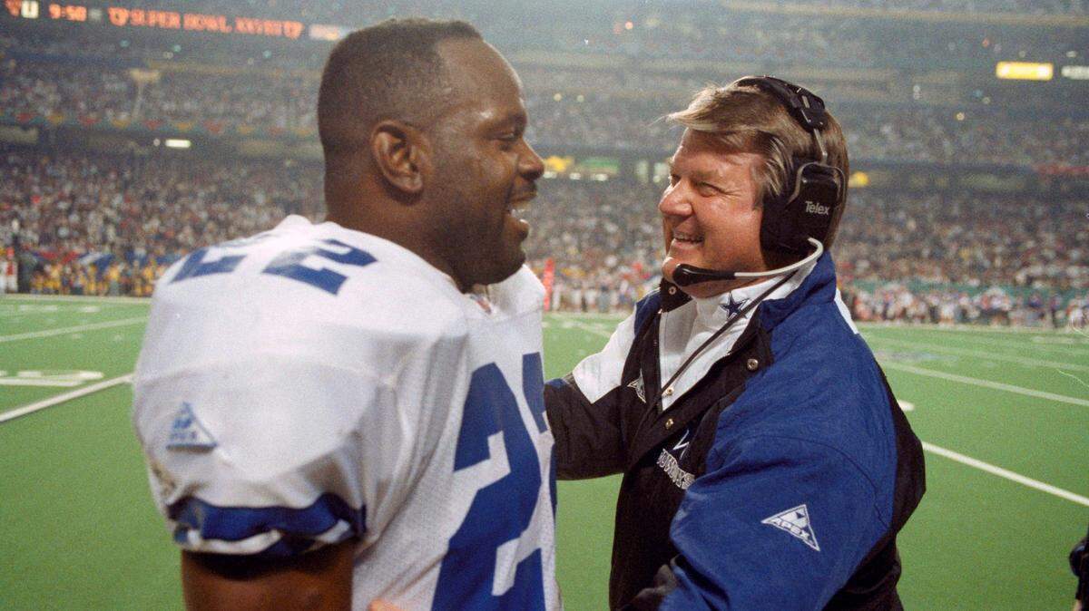 In this 1994 file photo, former Dallas Cowboys’ head coach Jimmy Johnson, right, talks with running back Emmitt Smith on the sidelines during the fourth quarter against the Buffalo Bills at the Super Bowl in Atlanta. Smith is joining NASCAR as a team owner.