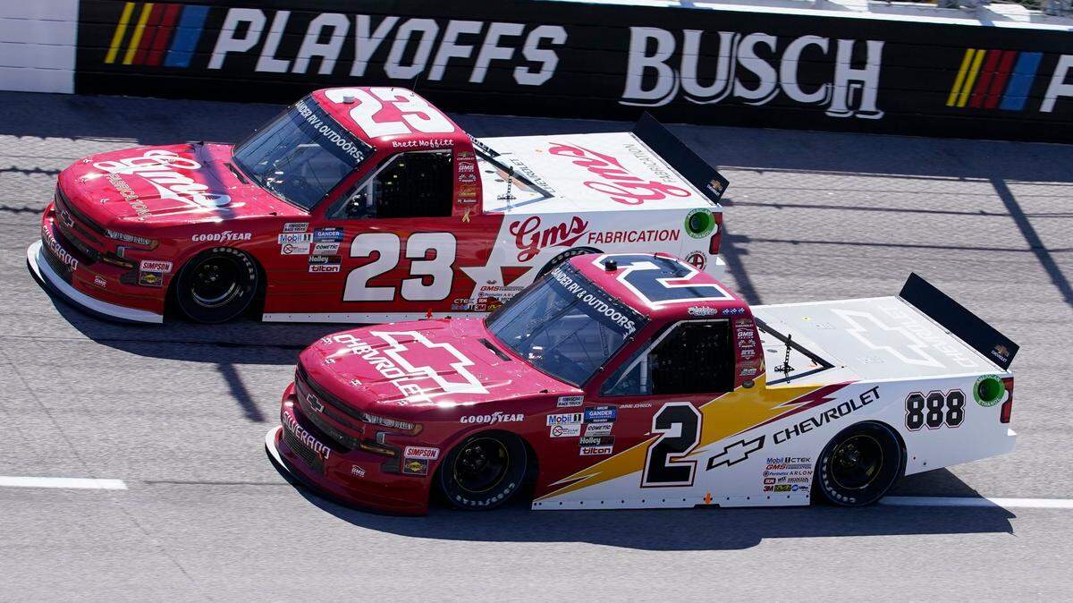 FILE - Sheldon Creed (2) and Brett Moffitt (23) vie for a spot on the track during a NASCAR Truck Series auto race in Darlington, S.C., in this Sunday, Sept. 6, 2020, file photo. The underappreciated Truck Series opens NASCAR’s championship weekend with an under the lights Friday night Nov. 6 shootout that could be the most entertaining event at Phoenix Raceway. The path to the winner-take-all finale has been a flat-out demolition derby with two consecutive weeks of wild driving. (AP Photo/Chris Carlson, File)