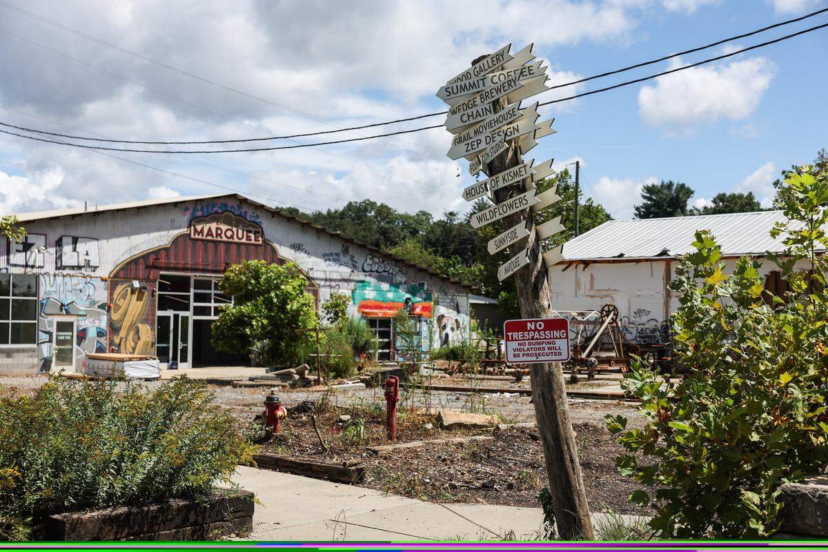 The River Arts District in Asheville sits in ruins after devastating flooding from the French Broad River last year during Helene.