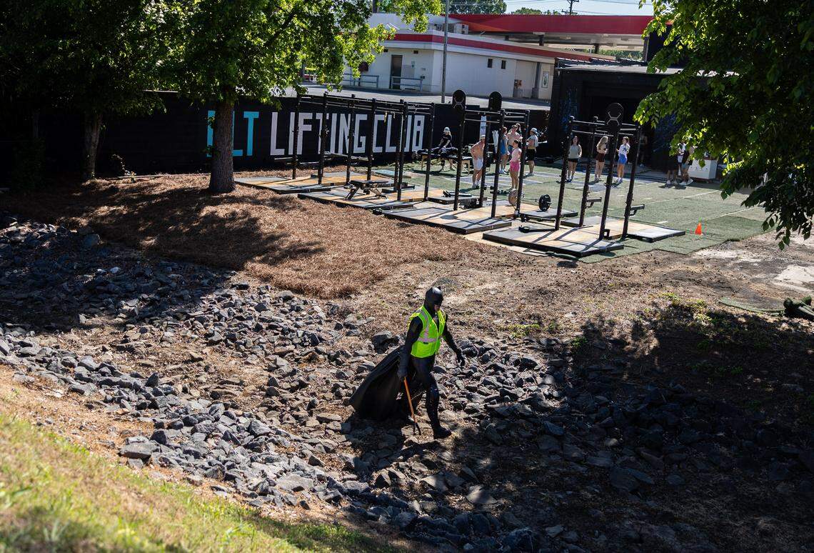 The Batman of Charlotte, D.J., volunteers to pick up trash along the Charlotte Rail Trail in Charlotte, N.C., on Saturday, April 18, 2026.
