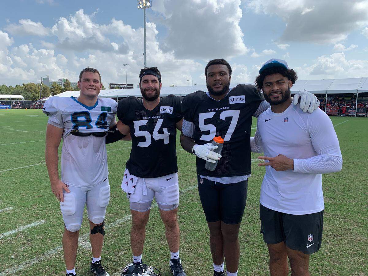 Notre Dame alums, Carolina Panthers tight ends Mitchell Evans (far left) and Tommy Tremble (far right), pose with fellow former members of the Fighting Irish, Houston Texans linemen Jarrett Patterson (middle left) and Blake Fisher (middle right) following joint practice in Houston, on Aug. 14, 2025 