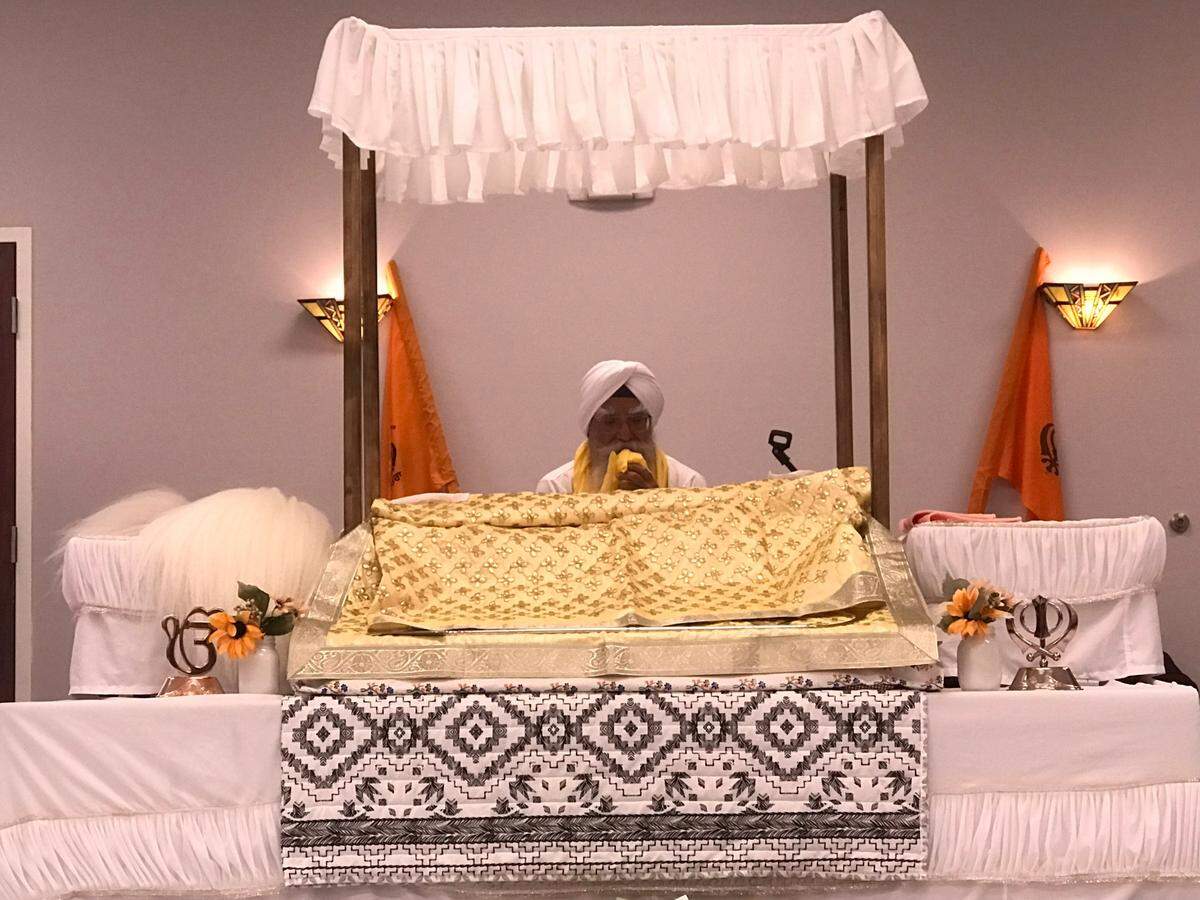 A Granthi reads from the Guru Granth Sahib, the holy book in the Sikh faith, at the Gurdwara Sahib Khalsa Darbar in Charlotte. The house of worship has been the subject of repeated acts of vandalism since fall of 2022. Taken Jan. 22, 2023