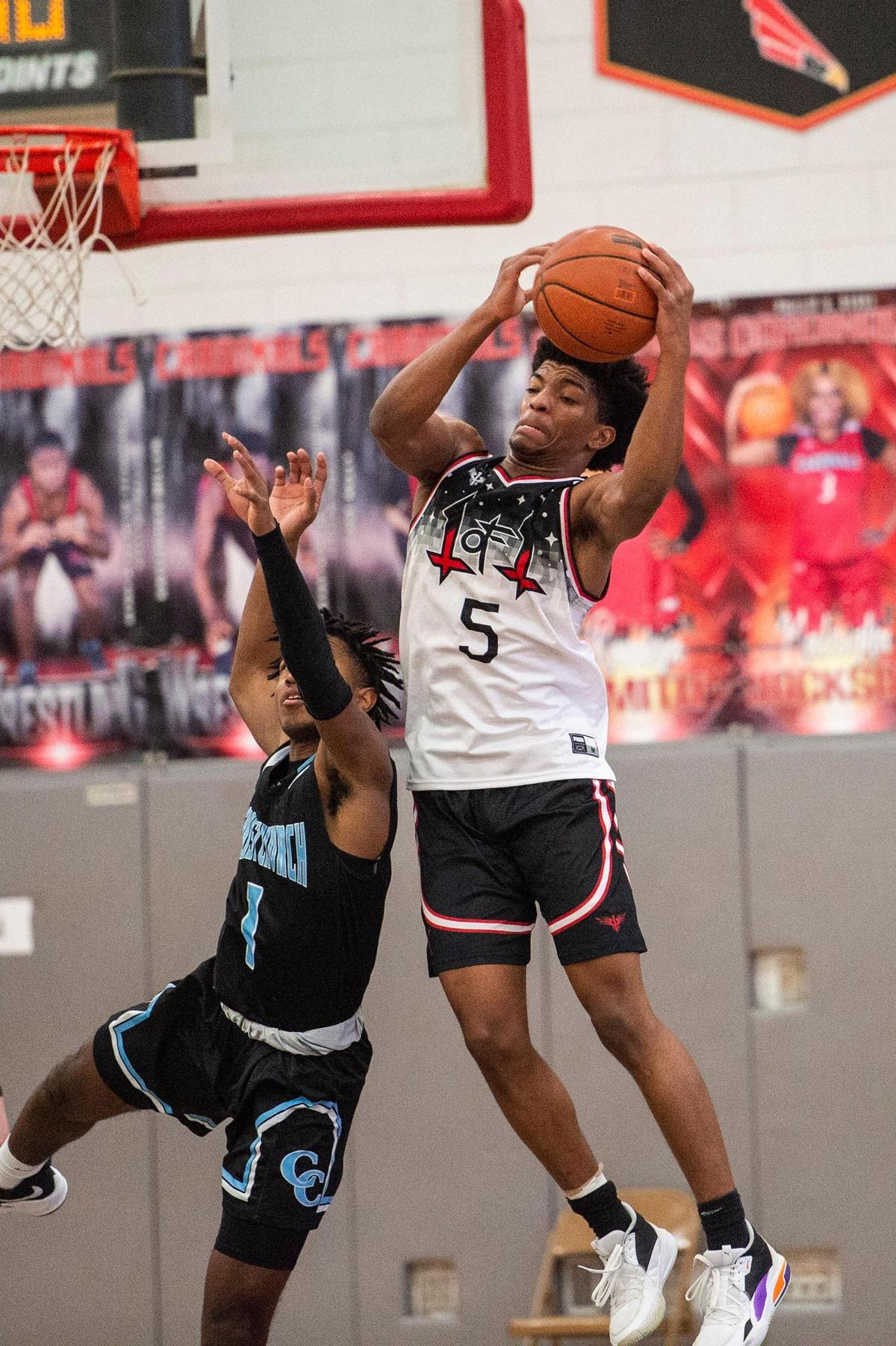 1-of-1 Prep’s Orlando Lovejoy, right, lgrabs the ball as he grabs a rebound during the game against Christ Church Episcopal at Berry High School on Saturday, January 29, 2021 in Charlotte, NC. 1-of-1 defeated Christ Church 70-59.