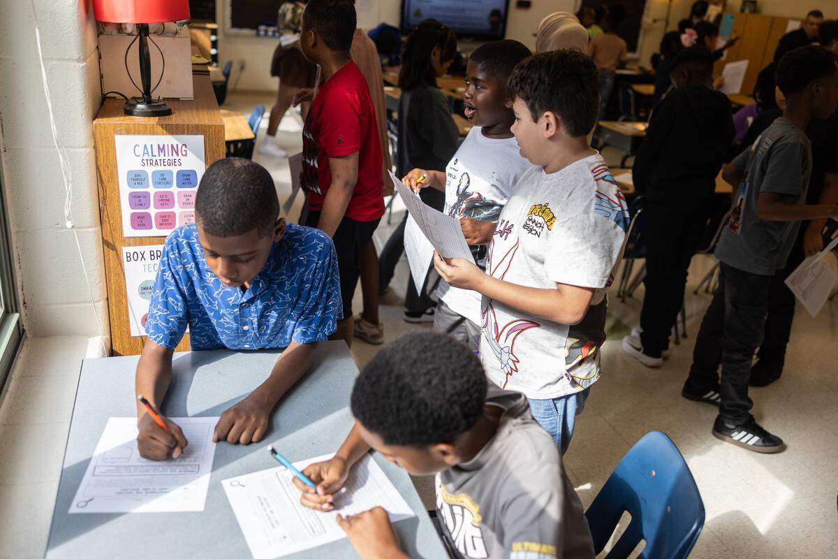 Students get started on their first assignment of the day during the first day of school at Elizabeth Traditional School in Charlotte, N.C., on Monday, August 25, 2025.