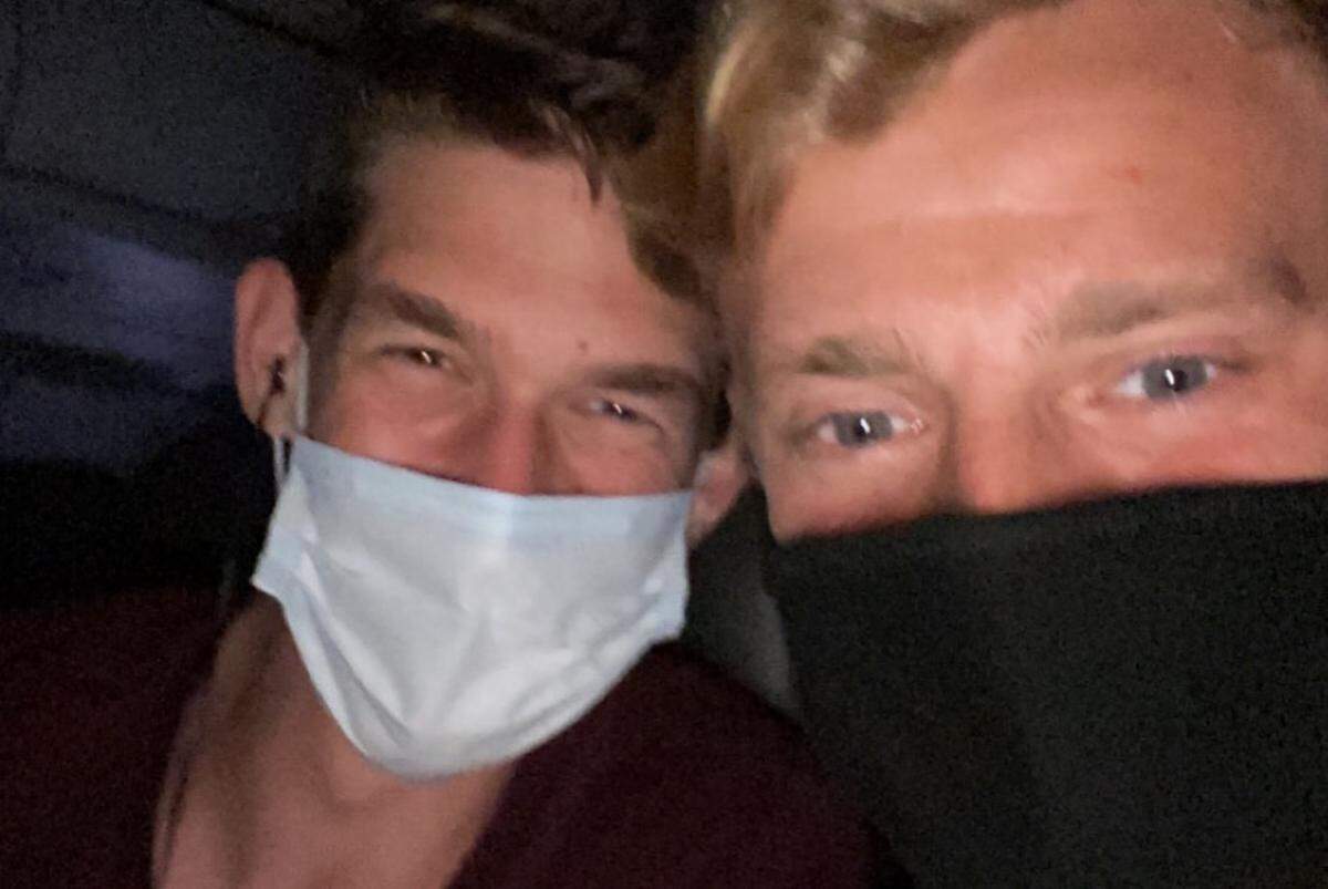 Austin Konkle, right, has flown with his boyfriend, Murphy, during the COVID-19 pandemic and felt safe.