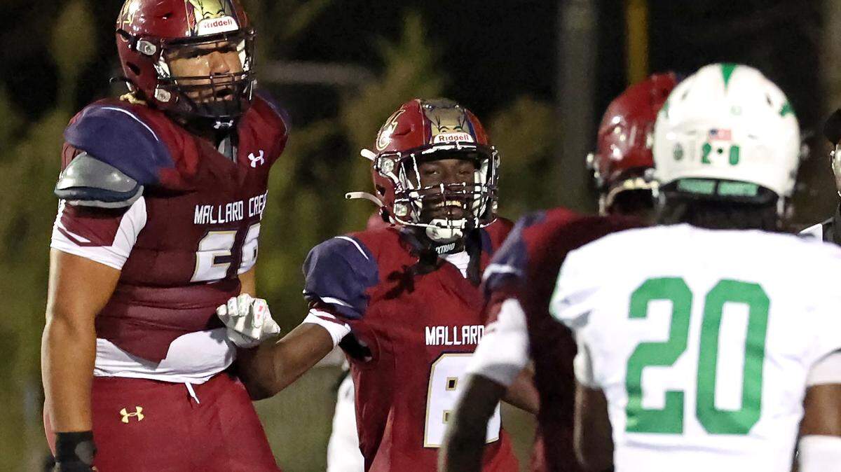 Mallard Creek Mavericks linebacker Braydon Wilson, center, smiles as he runs to celebrate a touchdown against the Myers Park Mustangs during action on Friday, September 12, 2025 at Mallard Creek High School. Mallard Creek defeated Myers Park 20-13.