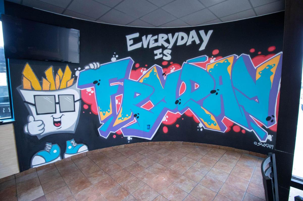 “Everyday is Fryday” at the new What The Fries restaurant, art by Swych19 proclaims.