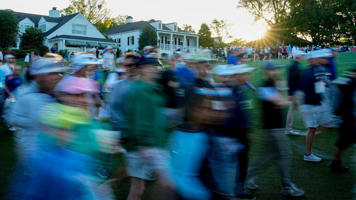 Patrons move onto the course Friday during the completion of the first round of the Masters Tournament.