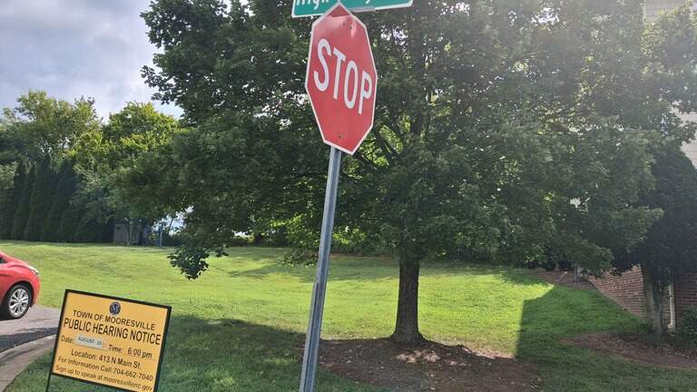 Divided board backs dozens of Lake Norman townhomes near this busy road