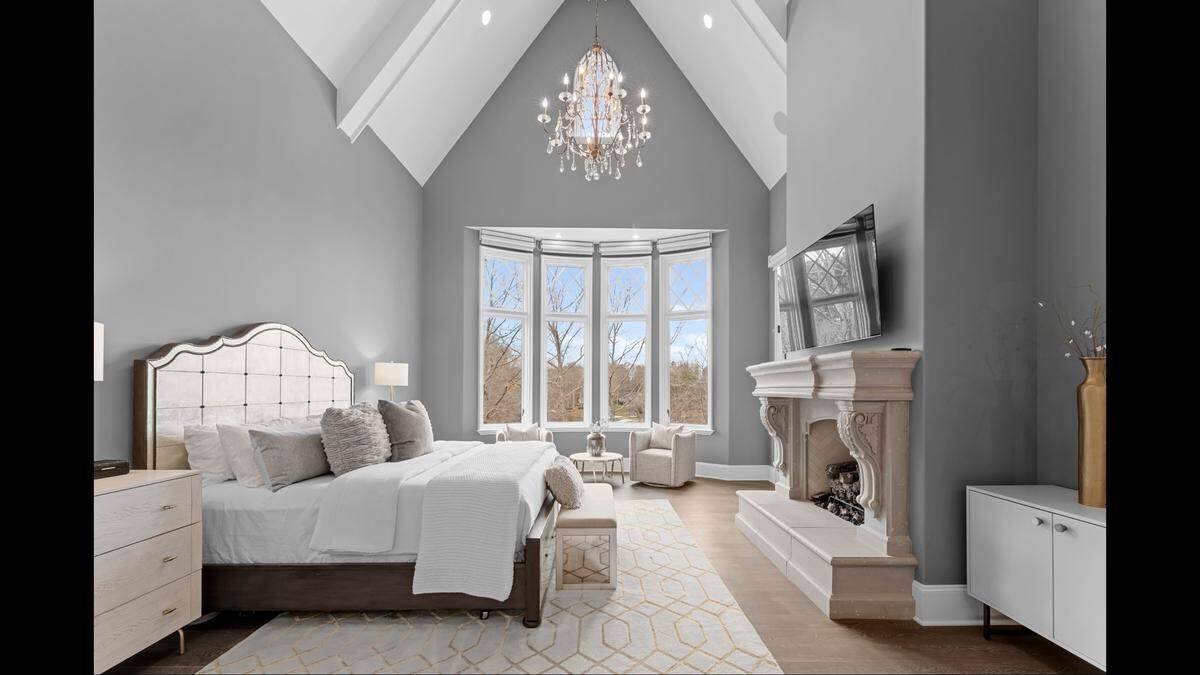 This bedroom of the mansion looks out to miles of mountains.