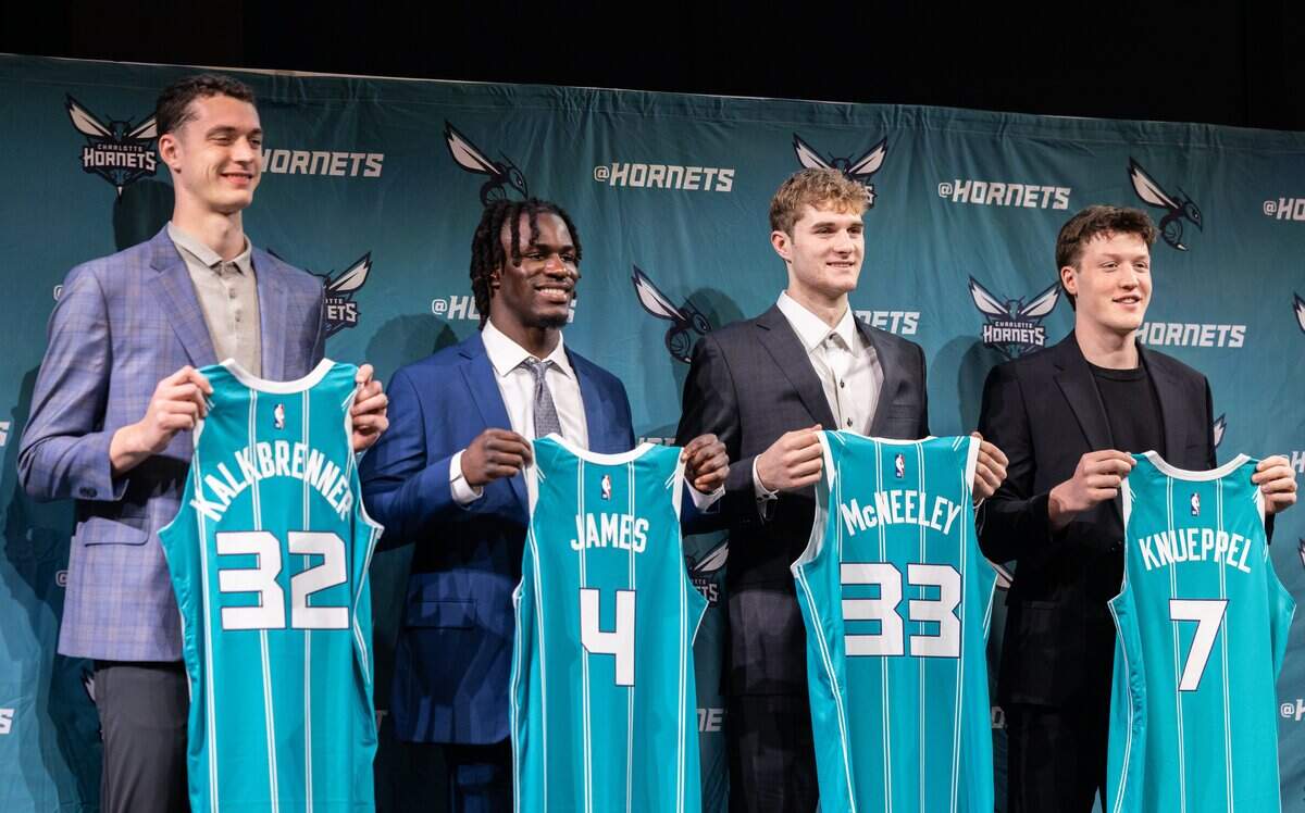 Hornet’s new players hold up jerseys during a press conference introducing them in Charlotte, N.C., on Friday, June 27, 2025. 