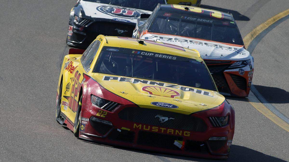 Joey Logano (22) leads Christopher Bell (95) and Kevin Harvick (4) out of Turn 4 during a NASCAR Cup Series auto race at Phoenix Raceway, Sunday, March 8, 2020, in Avondale, Ariz. (AP Photo/Ralph Freso)