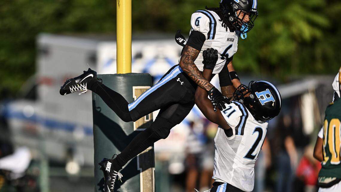 Hough wide receiver Jayden White (6) celebrates a touchdown with running back Jamarion Morrison (21) during the first half of a NCHSAA football game against Independence, Friday, Aug. 29, 2025, in Charlotte, N.C.