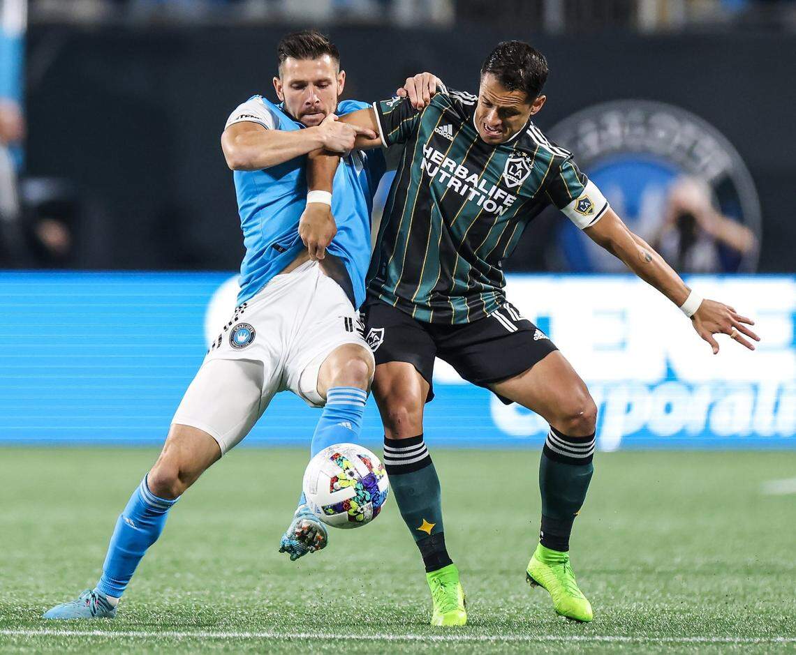 Charlotte FC Midfielder Brandt Bronico, left, and LA Galaxy Chicharito, right, fight for the ball at the Bank of America Stadium in Charlotte, N.C., on Saturday, March 5, 2022.