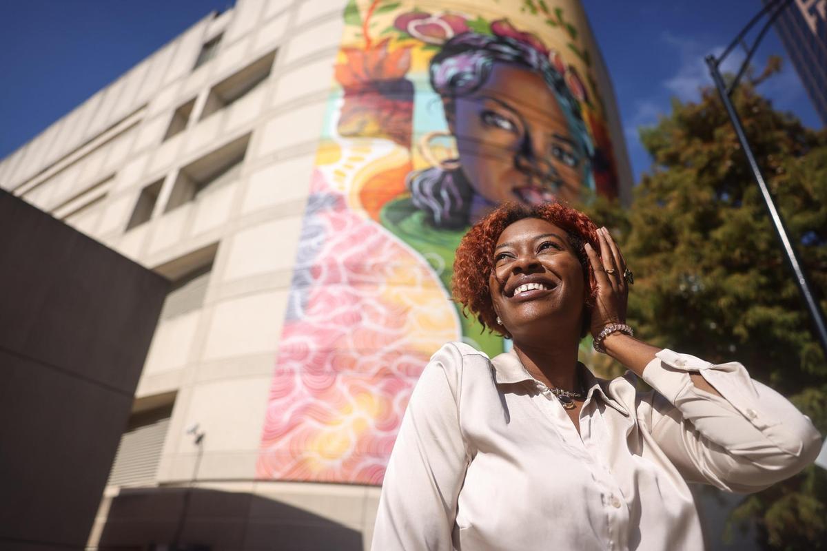 Dionna Bright was the subject of the mural behind her. “When I thought about this piece, I wanted someone who brings me light and is a source of joy,” one of the artists said.