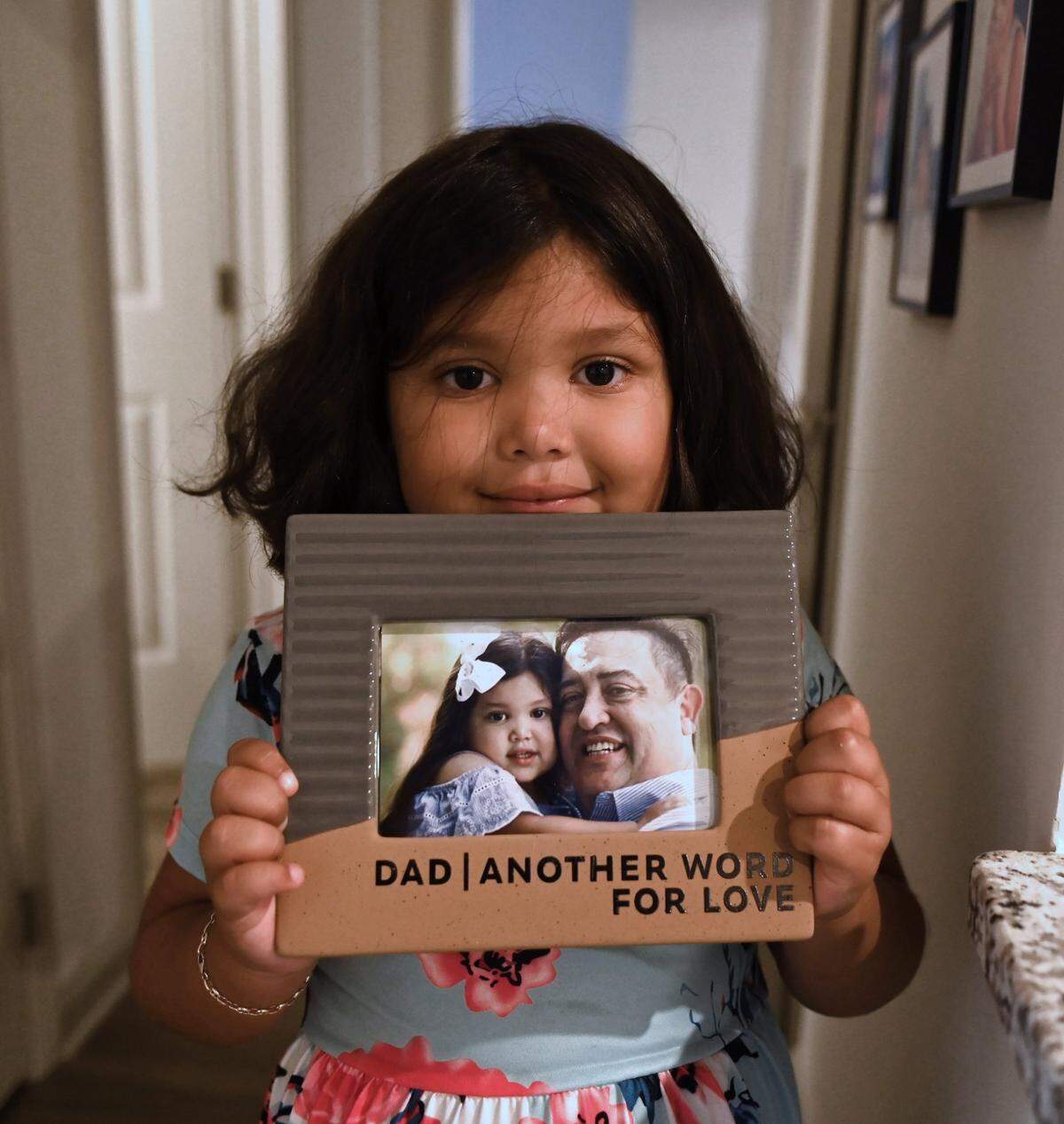 Charley Freiberg, 5, holds a photo of her and her father, Jimmy Freiberg, June 8, 2022. Jimmy Freiberg, 48, was killed in an apartment near the 10000 block of Hillgrove Lane in Charlotte, NC on Saturday, March 5, 2022. Freiberg was hit by a bullet as he ran to protect his wife, Vanessa and daughter, Charley from the gunfire. Charley was born on Father’s Day in 2016 and will turn 6 on Father’s Day 2022. Charley and her mom, Vanessa have been stricken with grief since the sudden and tragic loss of Jimmy Freiberg but plan to make this Father’s Day a celebration.