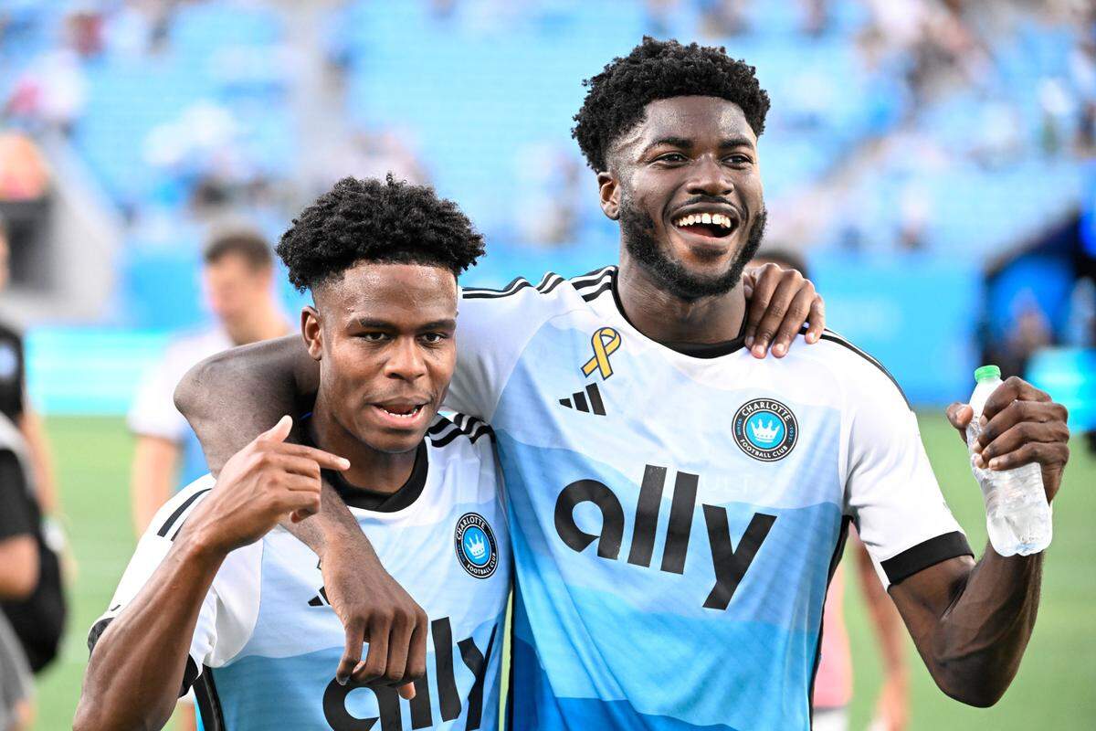 Sep 21, 2024; Charlotte, North Carolina, USA; Charlotte FC midfielder Brandon Cambridge (36) and forward Patrick Agyemang (33) celebrate after the game at Bank of America Stadium. Mandatory Credit: Bob Donnan-Imagn Images