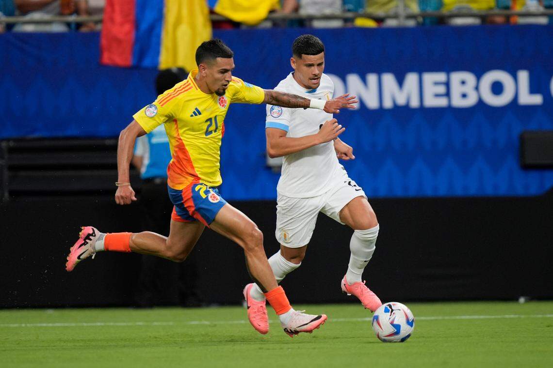 Colombia forward Munoz Mejia (21) and Uruguay forward Maximiliano Araujo (20) run up field during the first half at the Copa Armerica semifinal match at Bank of America Stadium. Colombia defeated Uruguay, 1-0, to advance to the final against Argentina.