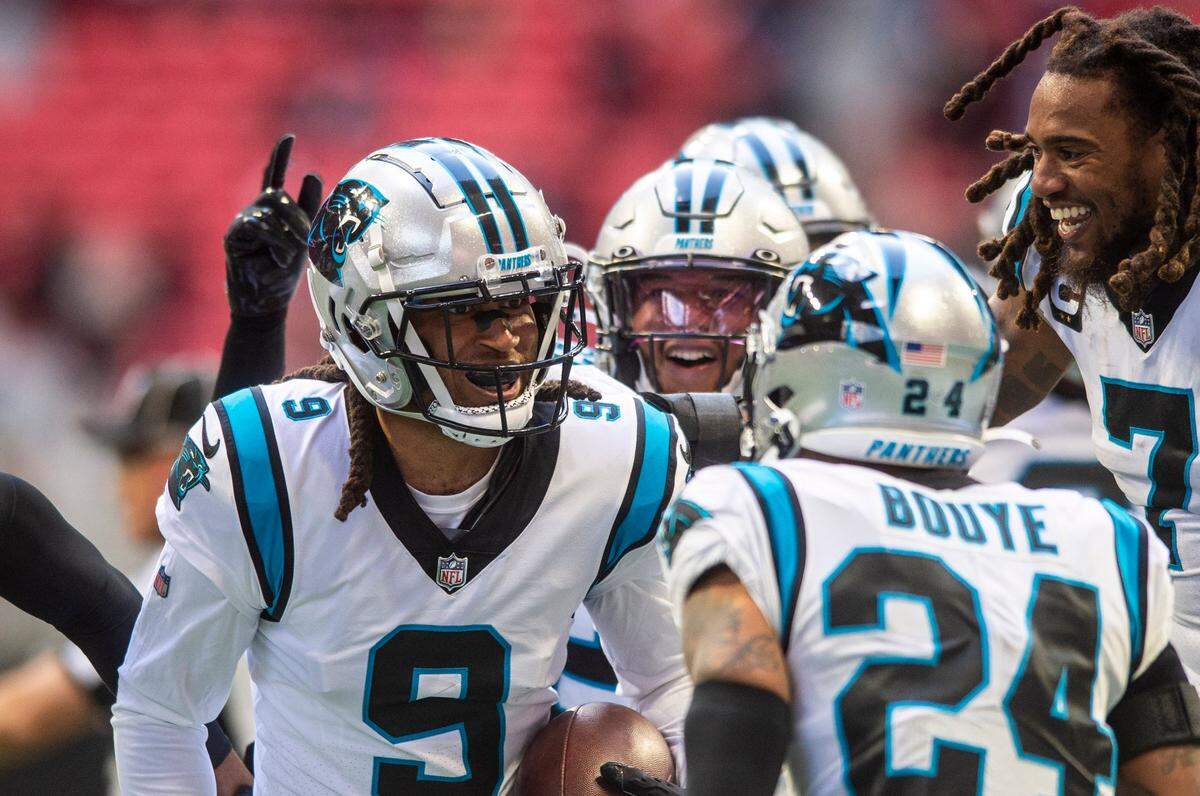 Panthers cornerback Stephon Gilmore, left, celebrates with teammates after making an interception during the game against the Falcons at Mercedes-Benz Stadium on Sunday, October 31, 2021 in Atlanta, GA. It was Gilmore’s first interception in his first game for the Panthers, the team he grew up rooting for as a child.