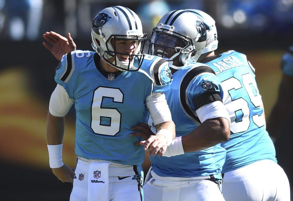 Carolina Panthers’ Taylor Heinicke (6) is congratulated by Carolina Panthers’ Cam Newton (1) after a play against the Baltimore Ravens in the first half of an NFL football game in Charlotte, N.C., Sunday, Oct. 28, 2018. (AP Photo/Mike McCarn)