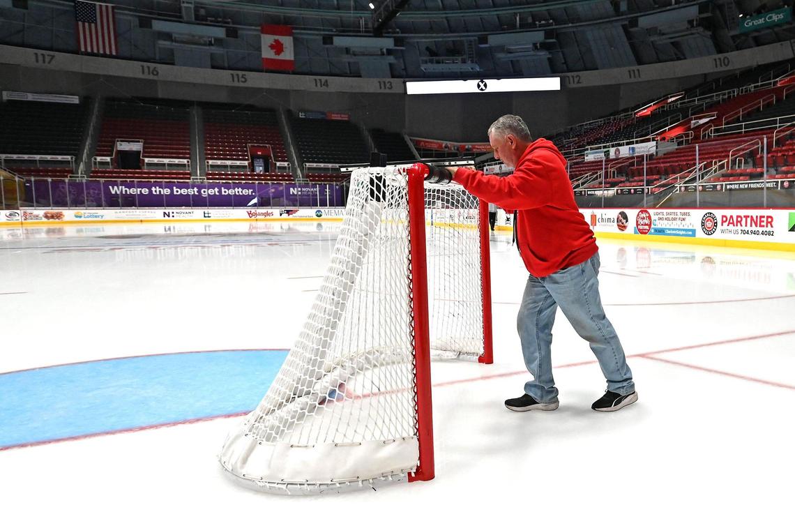 Certified Ice Technician Tony Caddy positions a goal on the ice at Bojangles Coliseum in Charlotte, NC on Friday, October 18, 2024. The Charlotte Checkers hosted the Cleveland Monsters in the home opener.