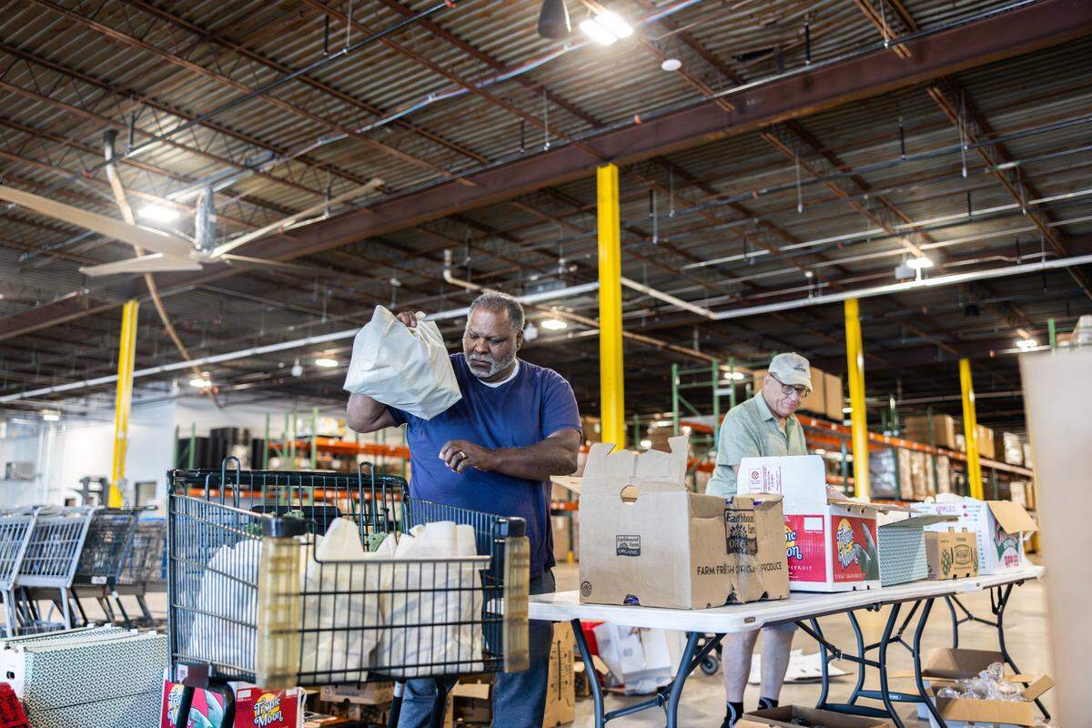 Volunteers pack bags of groceries at the new Nourish Up warehouse in Charlotte on Tuesday, June 11, 2024. The Tepper Foundation is donating $3 million to Nourish Up.