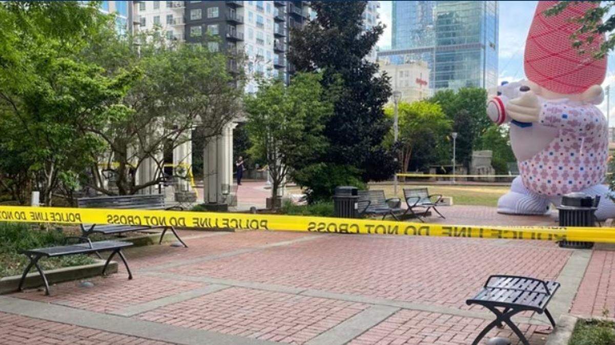 Police tape is stripped over part of Romare Bearden Park in Charlotte Sunday. Two people were shot there and have life-threatening injuries.