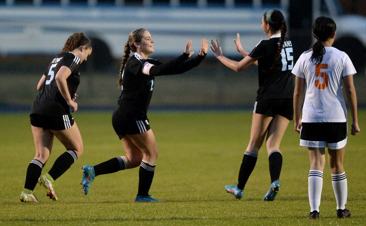 Hopewell HighÕs Corinne Peterman, center and Emmy Vidarte, right, celebrate a goal by Peterman during action against Rocky River on Tuesday, March 8, 2022. Hopewell defeated Rocky River 11-0.