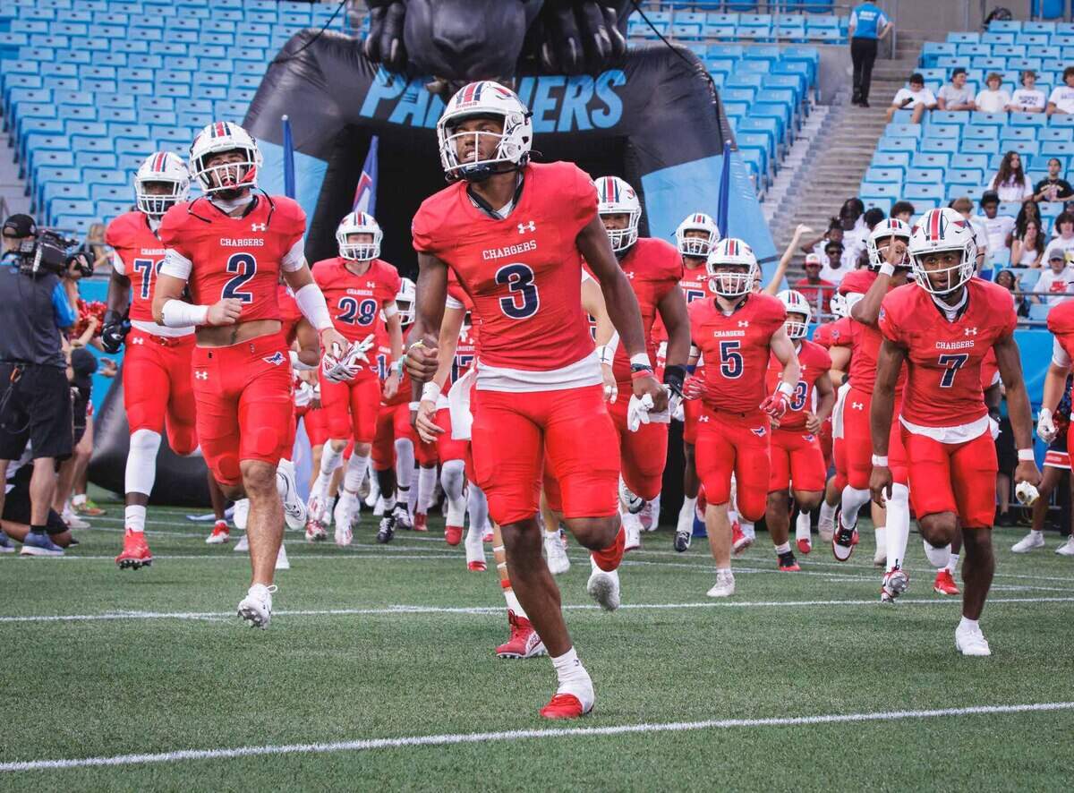Providence Day’s Jordan Shipp leads his team onto the field at Bank of America Stadium Saturday night.