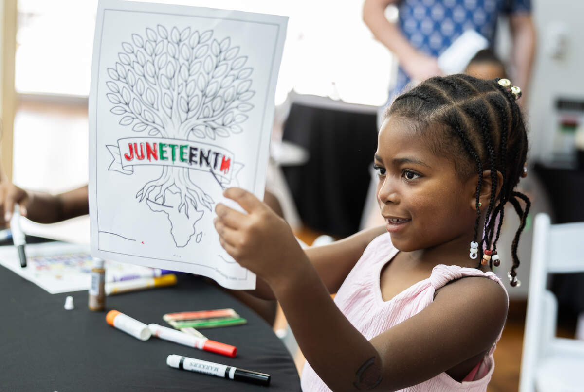 Joy Belk, 5, shows off her Juneteenth coloring page during Juneteenth at The Gantt at Harvey B. Gantt Center for African-American Arts + Culture in Charlotte, North Carolina, on Friday, June 19, 2026.