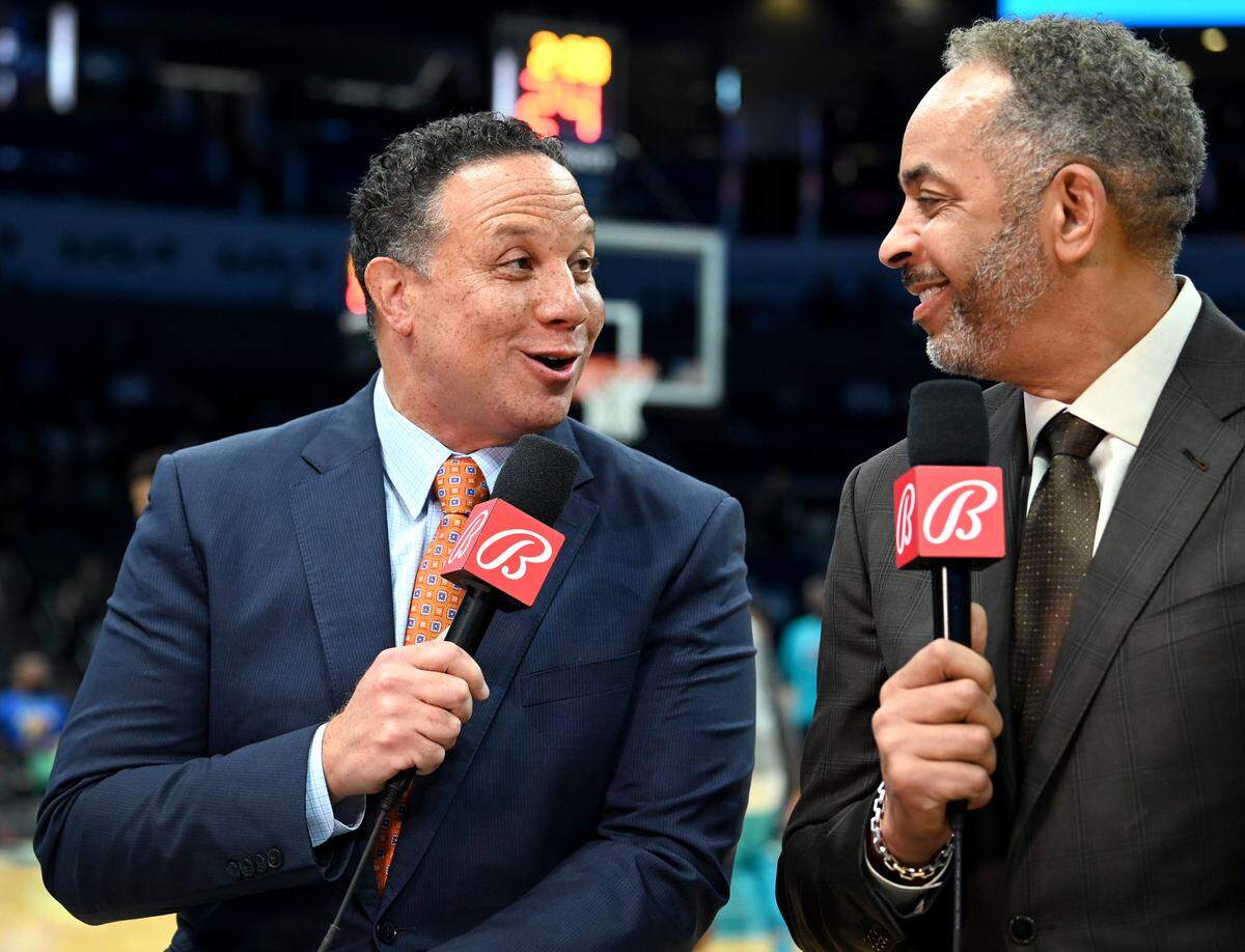 Charlotte Hornets play-by-play sports announcer Eric Collins, left, and color commentator Dell Curry, right, in 2022, as the Charlotte Hornets faced the Boston Celtics at Spectrum Center.