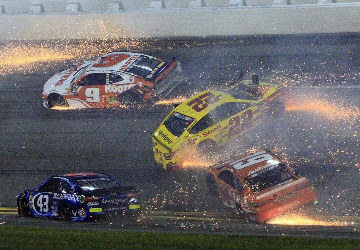 Chase Elliott (9), Darrell Wallace Jr (43), Joey Logano (22) and Daniel Suarez (19) wreck during the NASCAR Cup Series auto race at Daytona International Speedway, Saturday, July 7, 2018, in Daytona Beach, Fla. (AP Photo/Ron Sander)