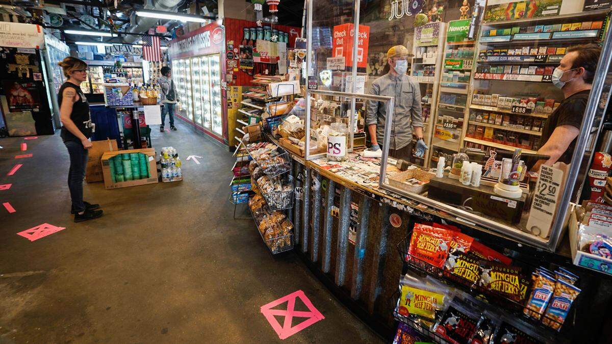 A customer shops in the Common Market on Commonwealth Avenue on Monday, May 11, 2020, as part of  Phase 1 reopening of merchants in North Carolina.
