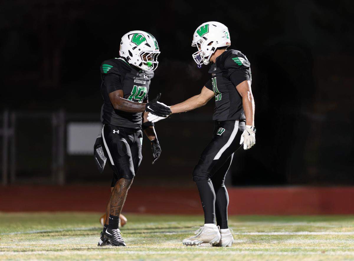 Weddington's Brayden Briles (left) and James Colonna (right) celebrate knocking down an Independence deep pass during early 1st quarter action. Weddington would host Independence in the NCHSAA quarterfinal playoff game Friday, November, 28 2025.