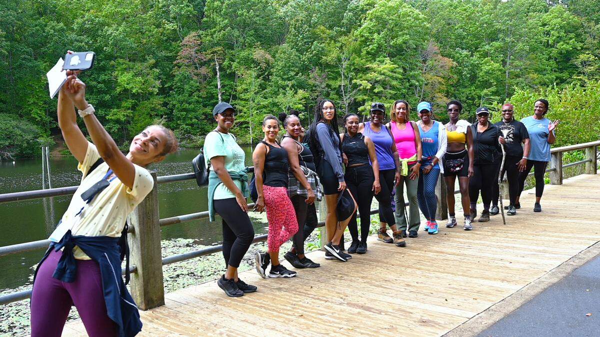 Lisa Vernon Sparks, Race, Culture, and Community Engagement Editor for The Charlotte Observer, takes a selfie with the “Black Girls Do Hike” group at Reedy Creek Park in East Charlotte.