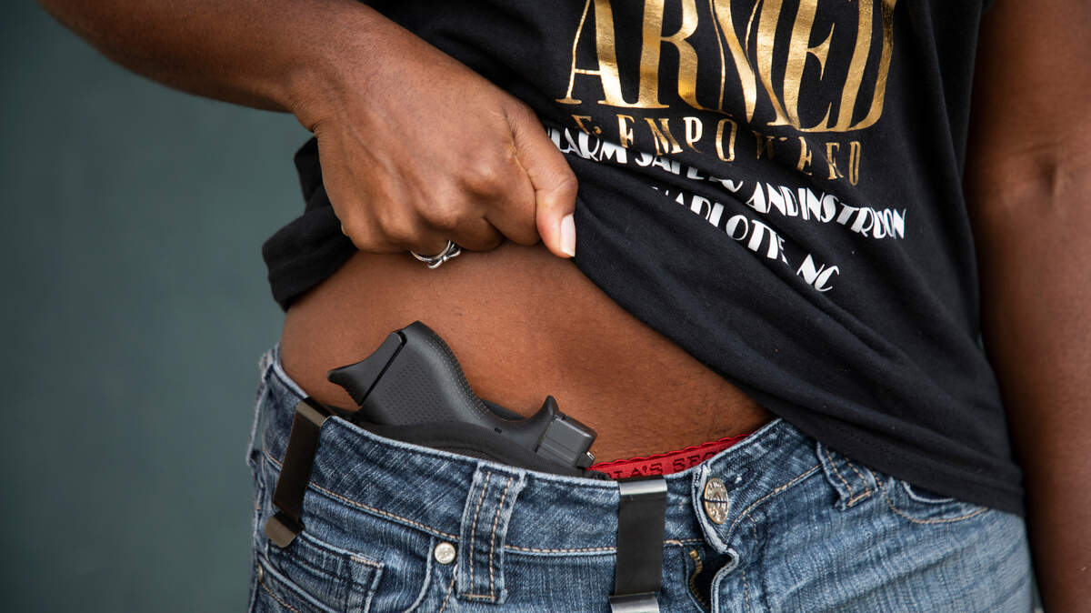 Kisha Kincaid shows her gun at a gun range in Concord, N.C., on Wednesday, August 17, 2022.