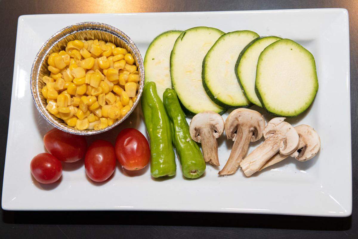 Veggies prepped for grilling are served at Gyu Kaku.