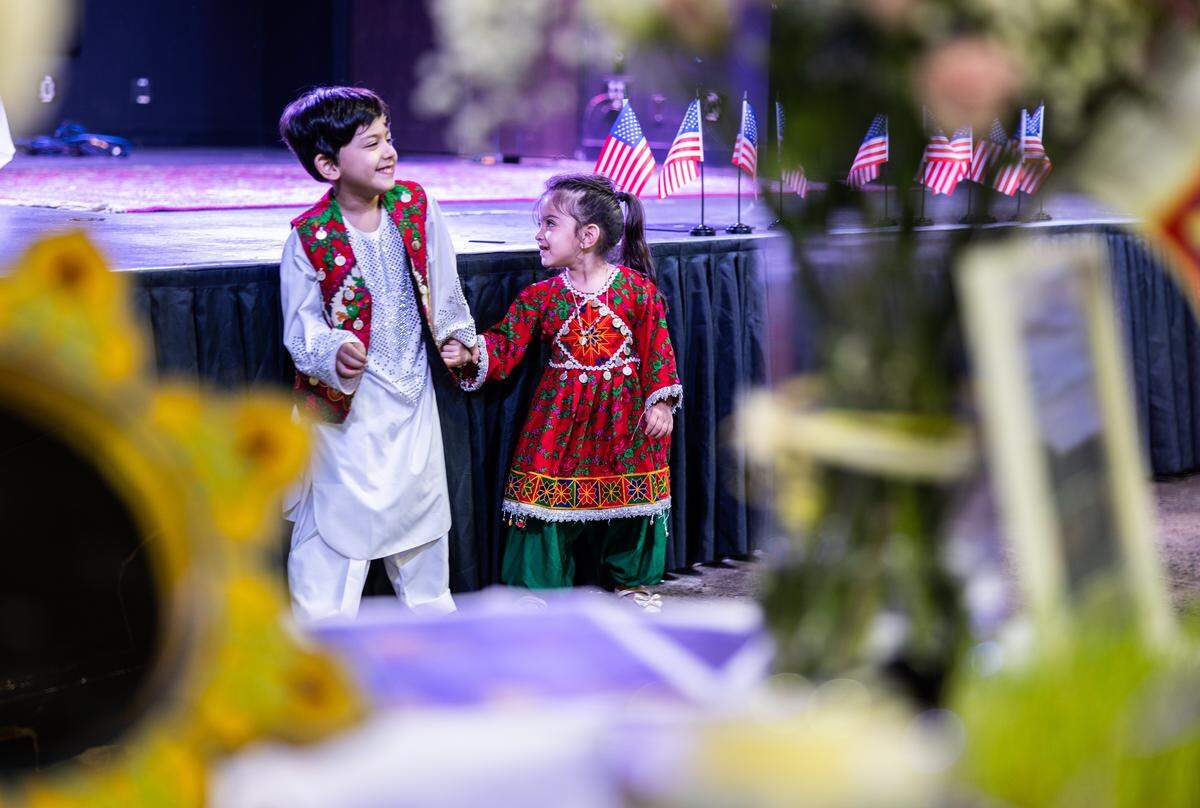 Children play while wearing traditional Persian costumes during the Nowruz Bazaar in Charlotte, N.C., on Sunday, March 15, 2026.