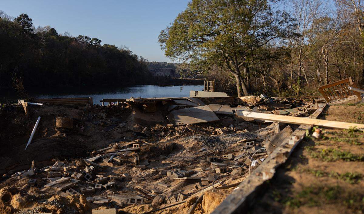 A look at properties where homes were washed away from Riverhaven Drive, with the Mountain Island Lake spillway off in the distance.