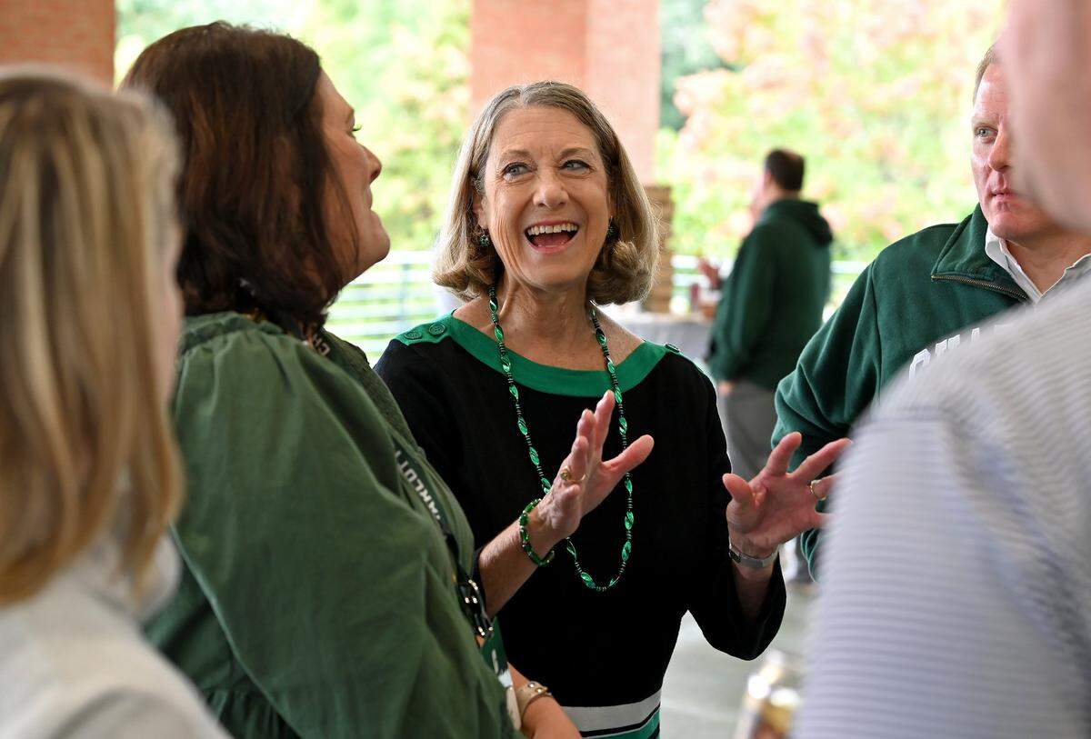 Former Charlotte 49ers athletic director Judy Rose, center, talks with alumni on Saturday, October 1, 2022. Rose served as the school’s athletic director for 28 years and was inducted into the school’s athletic hall of fame in September 2022.